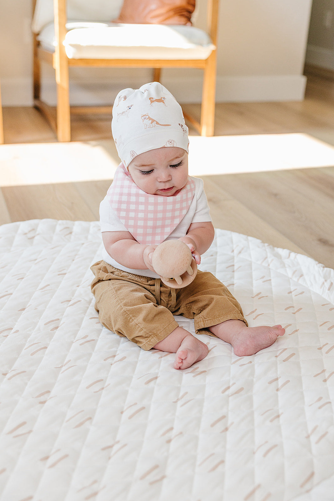 Organic Pima Cotton knotted hat by August & Ivy™, showing a soft, natural-colored knitted hat with a stylish knot detail.