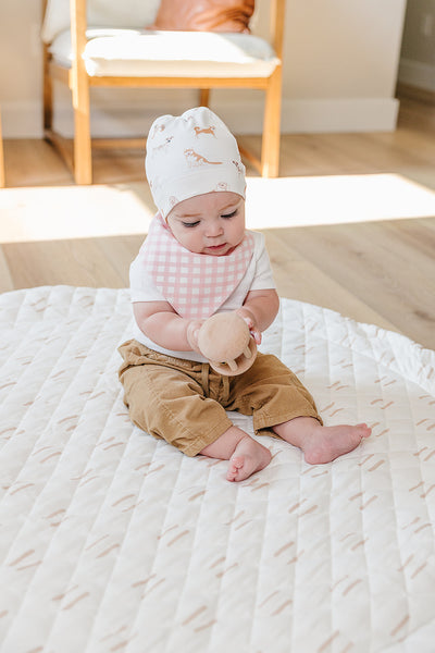 Organic Pima Cotton knotted hat by August & Ivy™, showing a soft, natural-colored knitted hat with a stylish knot detail.
