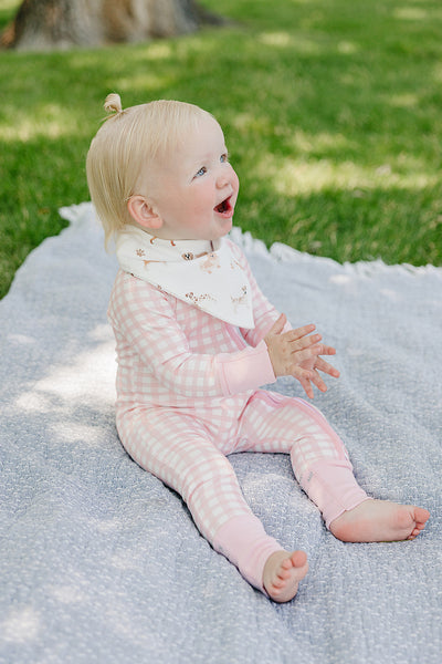 August & Ivy organic Pima cotton zip romper for babies, featuring soft, breathable fabric and easy front zipper closure.