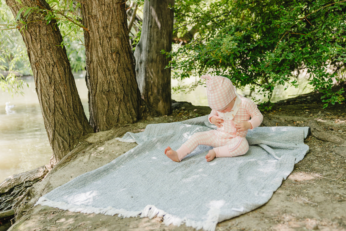 August & Ivy organic Pima cotton zip romper for babies, soft and comfortable with a front zipper design.