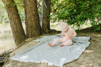 August & Ivy organic Pima cotton zip romper for babies, soft and comfortable with a front zipper design.
