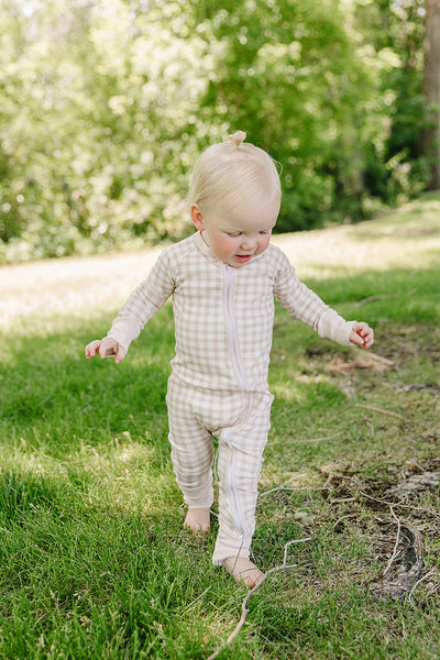 August & Ivy organic Pima cotton zip romper for babies, soft and comfortable one-piece clothing with front zipper.