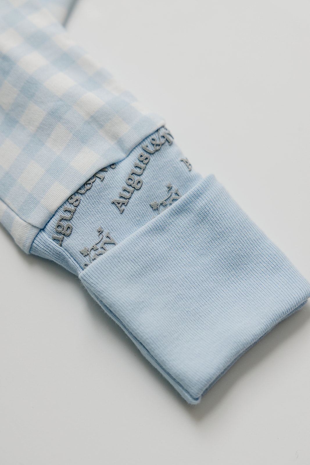 Organic Pima cotton zip romper by August & Ivy for babies, featuring a soft, comfortable design with a front zipper and playful pattern.