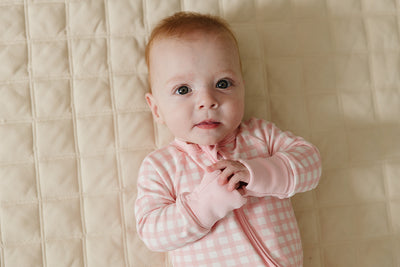 August & Ivy organic Pima cotton zip romper for babies, soft and comfortable one-piece clothing with front zipper closure.