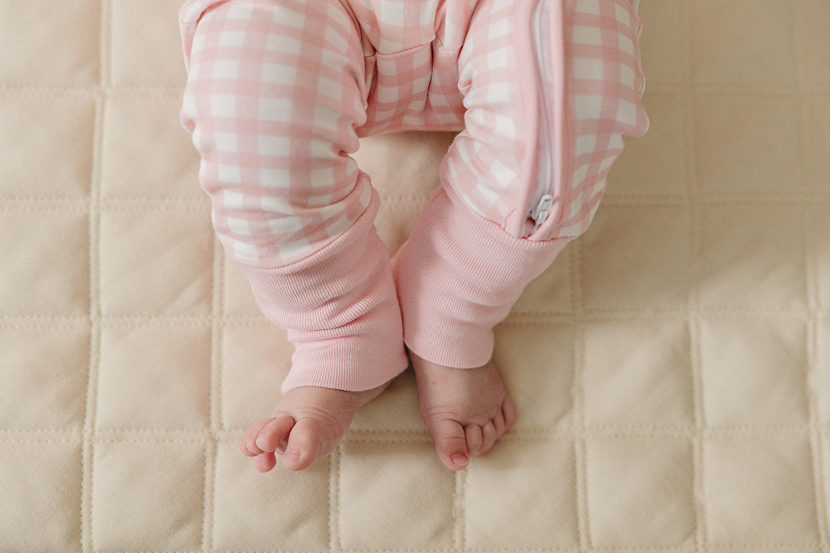 August & Ivy organic Pima cotton zip romper for babies, soft and comfortable with a front zipper and playful design.