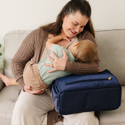 Comfortable breastfeeding position using structured diaper bag support