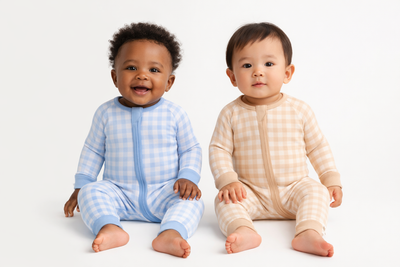 Organic Pima cotton romper by August & Ivy displayed on a baby mannequin, featuring soft fabric and comfortable design.