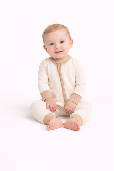 Organic Pima cotton romper by August & Ivy, featuring soft fabric and a comfortable fit for babies, shown in a close-up view.