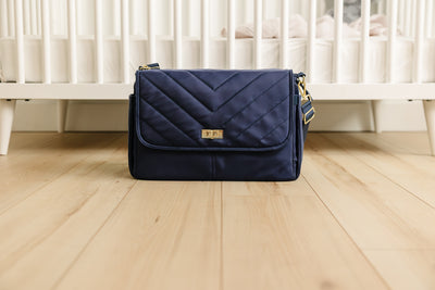 IvyGo™, the August & Ivy everyday companion, shown in a close-up image highlighting its sleek design and durable fabric. Structured diaper bag in Midnight Harbor, a modern diaper bag designed for organized parenting on the go.