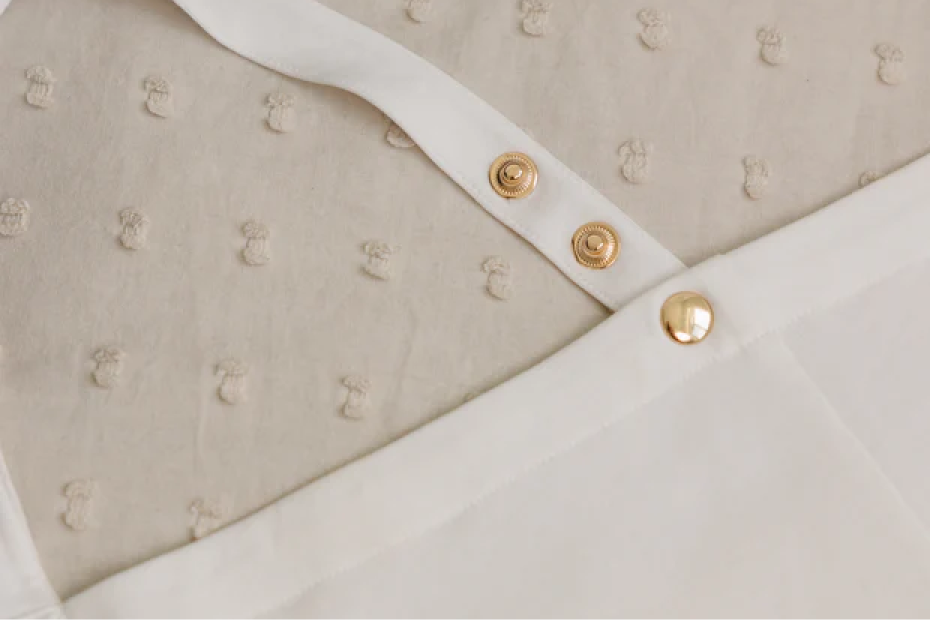 Close-up of the IvyGo nursing privacy cover featuring soft textured fabric and secure snap closures.