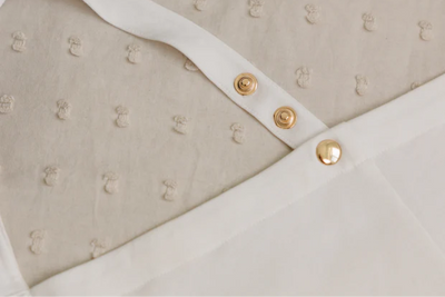 Close-up of the IvyGo nursing privacy cover featuring soft textured fabric and secure snap closures.
