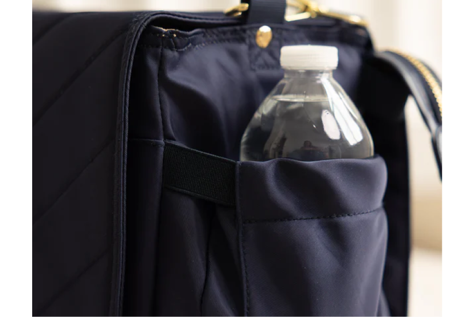 Deep side bottle pocket on the August & Ivy IvyGo diaper bag designed for easy-access bottles or water.