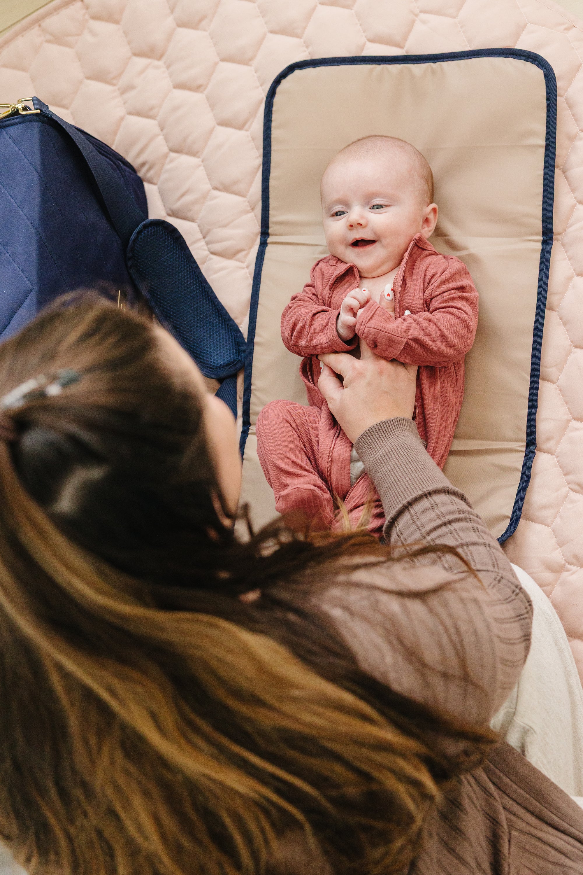 Happy mom using premium diaper bag for newborn essentials